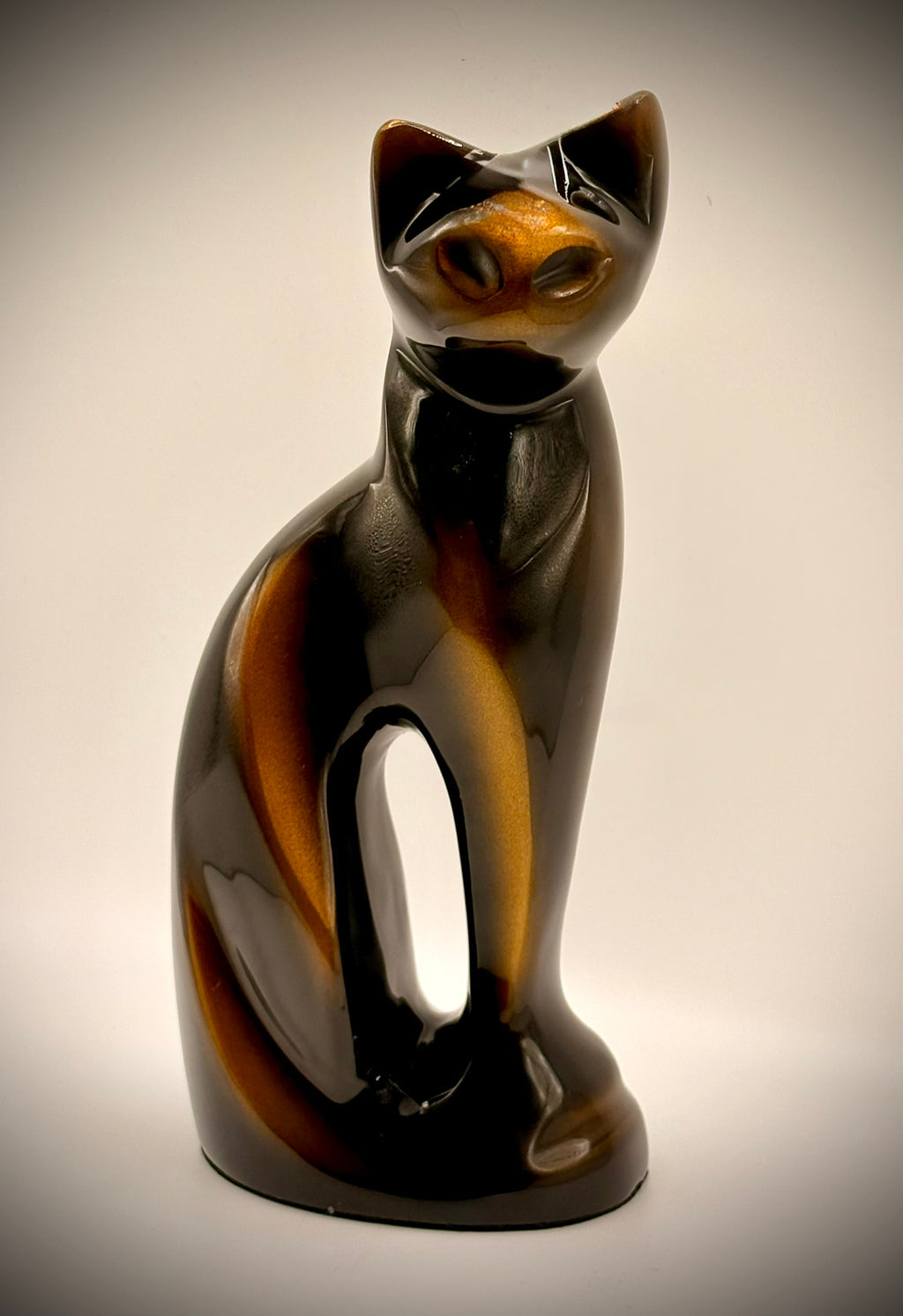 Cat-shaped figurine on a beige background